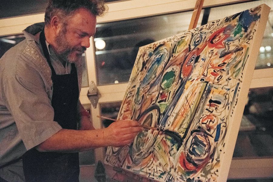Artist Nicholas Barron paints at a fundraiser. The fundraiser for Young Evanston Artists aimed to support putting on YEA! Day for a 31st year.