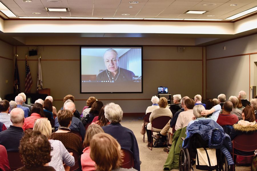 James Tusty video calls into an event at EPL on Saturday. Tusty is one of the filmmakers of “The Singing Revolution.” 