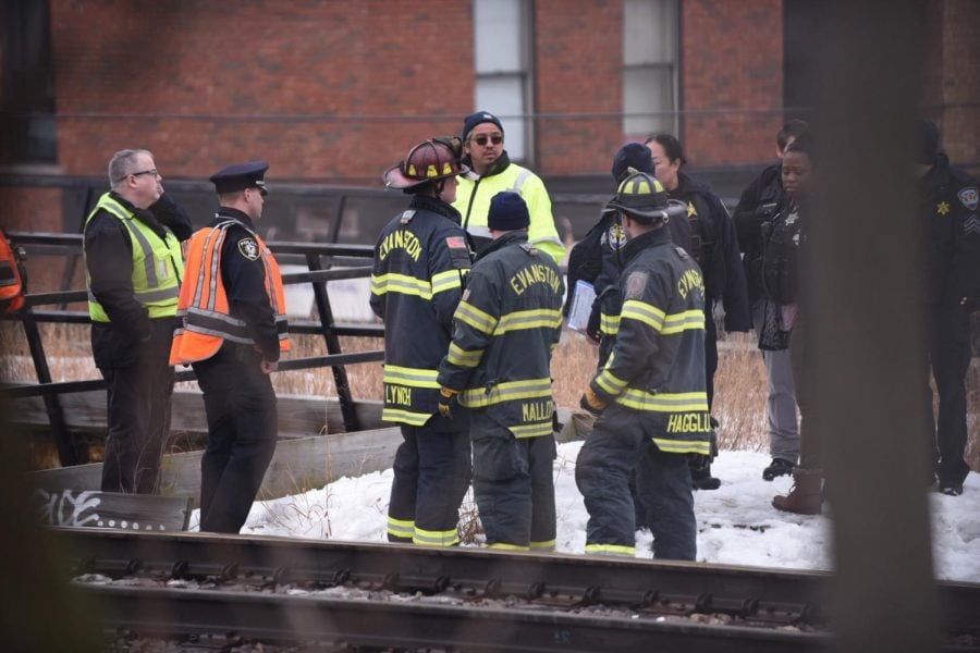 Officials work on the Metra tracks Thursday morning.