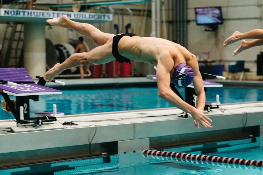 A Northwestern swimmer dives into the pool. The Wildcats finished ninth out of 10 teams at the Big Ten Championships.