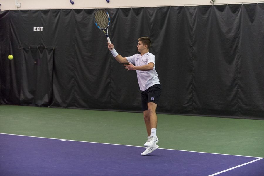 Michael+Lorenzini+strikes+a+forehand.+The+junior+and+the+Wildcats+went+1-2+on+a+busy+weekend.