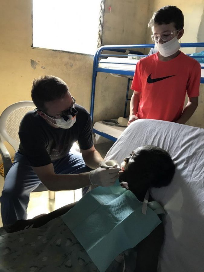 Dr. Brad Weiss provides dental work to a Haitian woman while his son Braden assists. They volunteered for a week in January as a part of a team organized by Rush University Medical Center and Community Empowerment. 