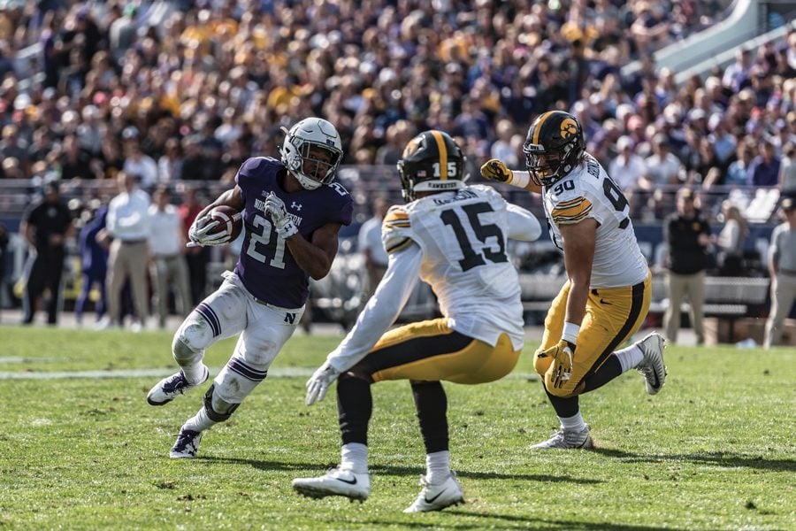 Justin Jackson eyes two Iowa defenders. The longtime Northwestern running back is likely to be chosen by an NFL team during this weekend’s draft.