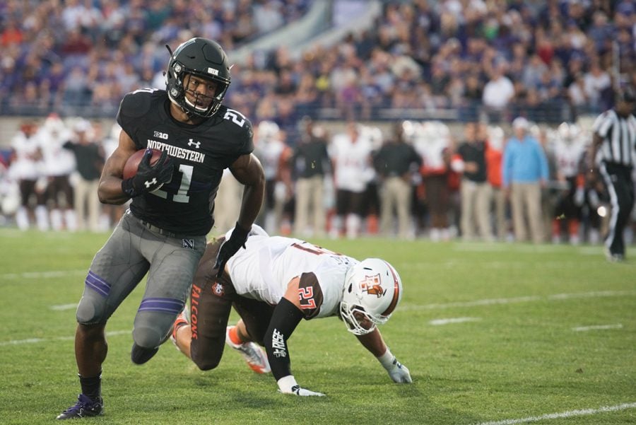Justin Jackson runs past a Bowling Green defender. The accomplished Northwestern running back was chosen in the seventh round of the NFL Draft on Saturday.