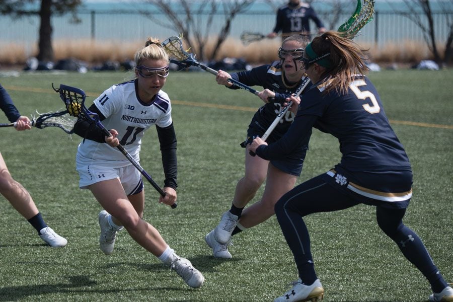 Ally Palermo evades two Notre Dame defenders. The freshman midfielder tallied a brilliant assist after a long run through the midfield, helping to spark Northwestern’s 20-10 win. 
