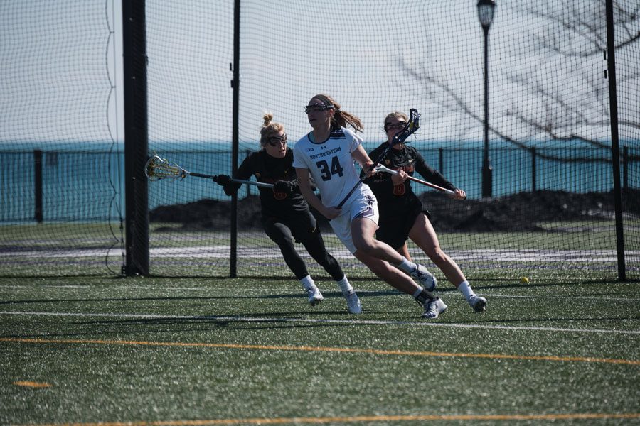 Holly Korn holds off two defenders. The 6-foot-2 attacker’s size and quick hands have helped her tally 15 goals so far this year.