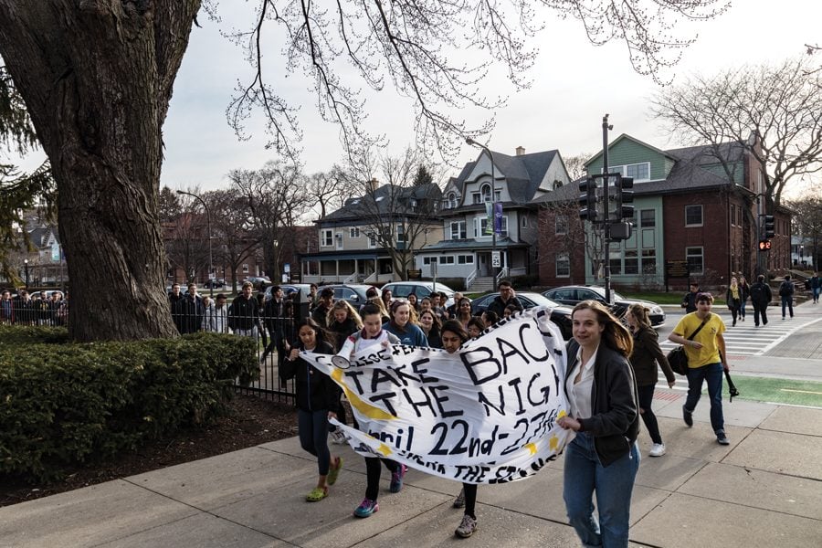 Students march from The Rock to Norris University Center in April for Take Back the Night. The event was held to raise awareness around sexual assault and provide support for survivors on campus. 