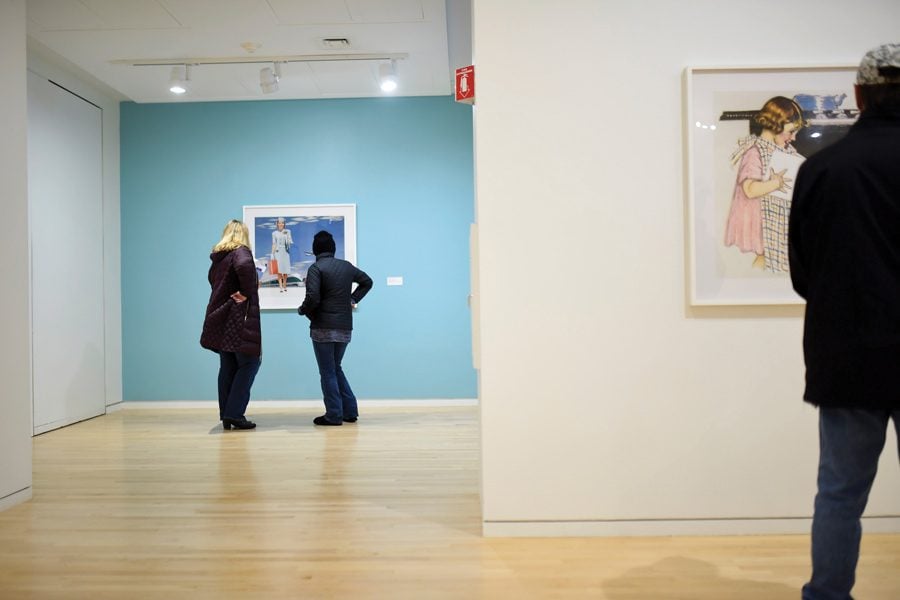 Gallery visitors look at a piece in “Hank Willis Thomas: Unbranded” at The Block Museum of Art. The exhibition opened Saturday and examines the portrayal of African Americans and white women in the media. 
