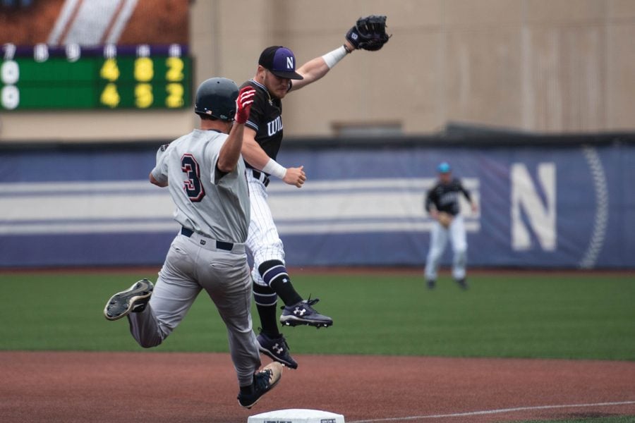 Northwestern first baseman Willie Bourbon and Belmont baserunner Ben Kocher stretch to tag the base first. Kocher’s Bruins took two of three games from the Wildcats in the weekend series. 