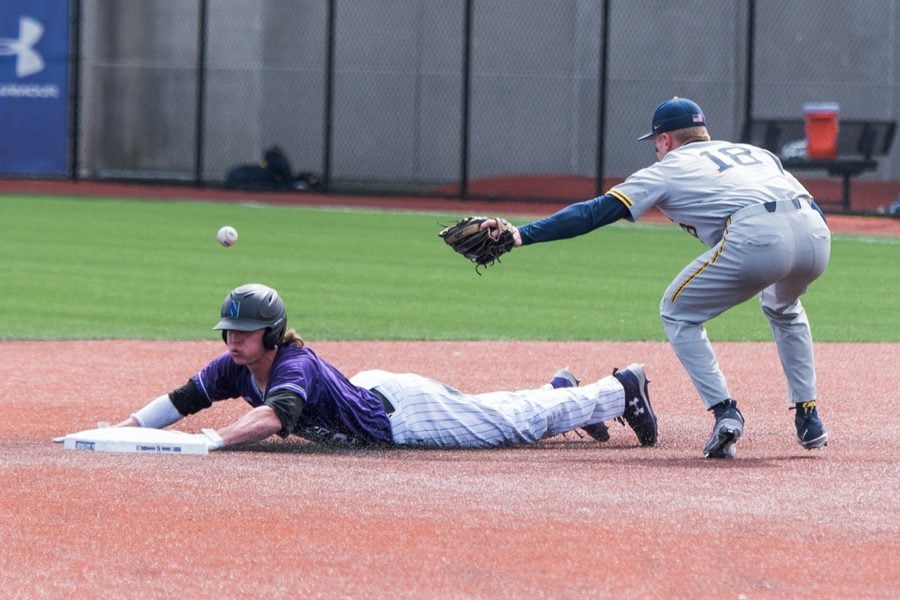 Jack Dunn slides in safely to second base. The junior shortstop walked off Friday’s win against Iowa.