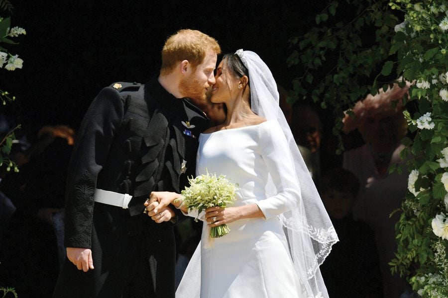 Prince Harry and Meghan Markle kiss on the steps of St Georges Chapel in Windsor Castle after their wedding Saturday, May 19, 2018 in Windsor, England. More than 20 Northwestern alumni made the trek to Windsor to catch a glimpse of Markle, who graduated from NU in 2003. 