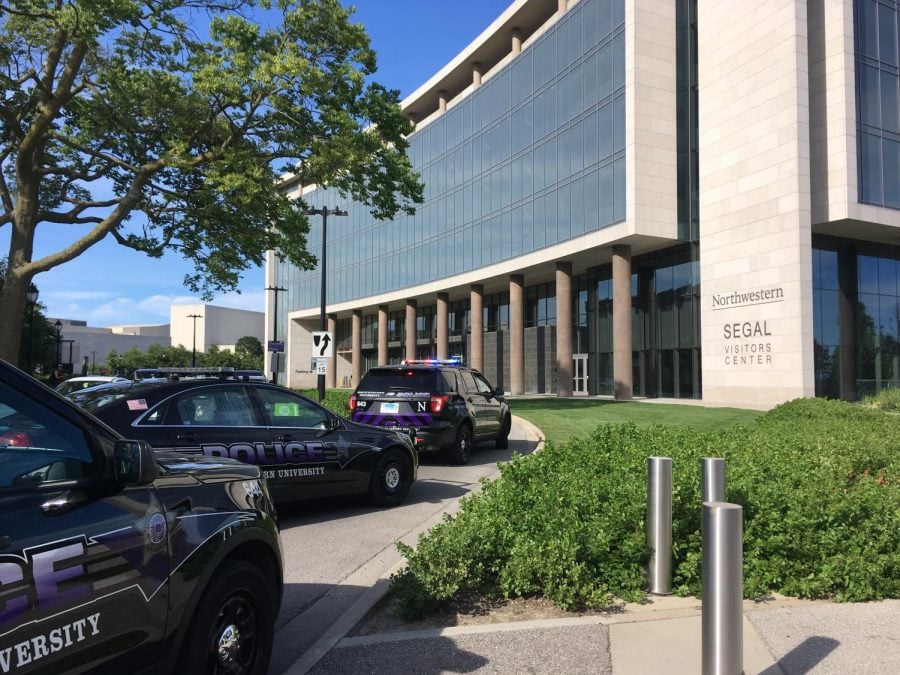 Northwestern police cars parked outside the Segal Visitors Center Tuesday evening after a man with a gun was reported on campus. The suspect, who had a wooden toy gun, was taken into custody and cited for disorderly conduct.