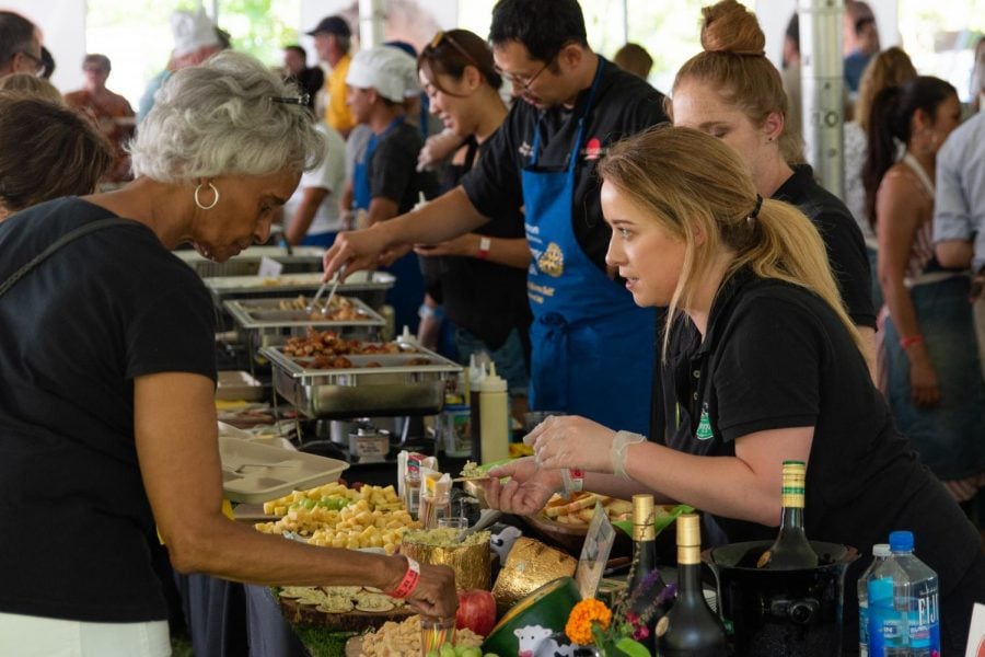 Community members get samples from various local food vendors at the fourth annual Taste of Evanston. This year’s event primarily benefited local nonprofits Connections for the Homeless and Reba Place Development Corporation.