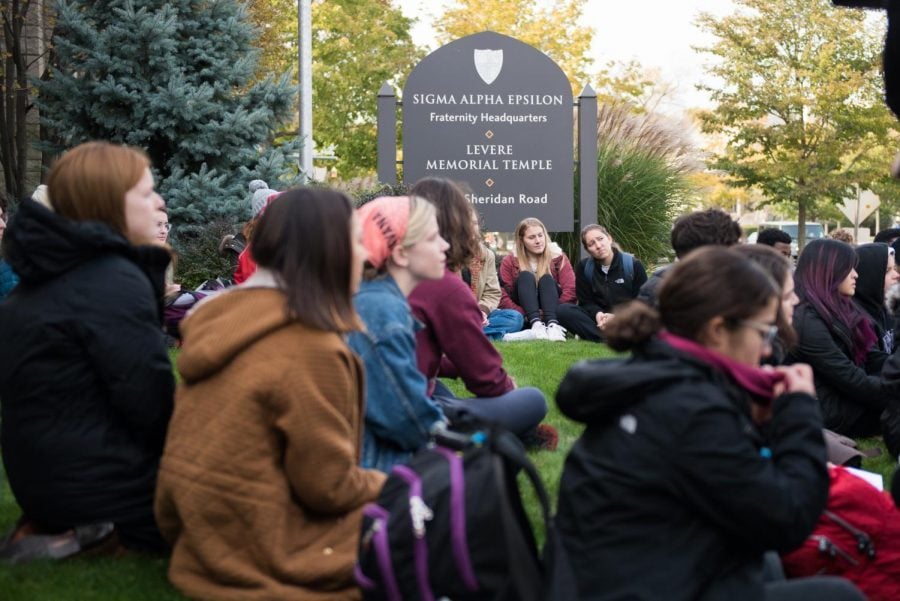 Students sit on the lawn of Sigma Alpha Epsilon’s headquarters in November 2017 as part of a protest to support survivors of sexual assault. The fraternity returns to campus this fall after a contentious history. 