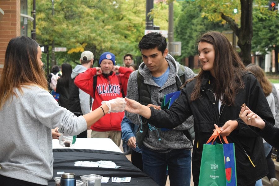 Students check in for Big Bite Night outside of Whole Foods. Sunday’s event, hosted in conjunction with Associated Student Government, showcased 33 Evanston restaurants. 
