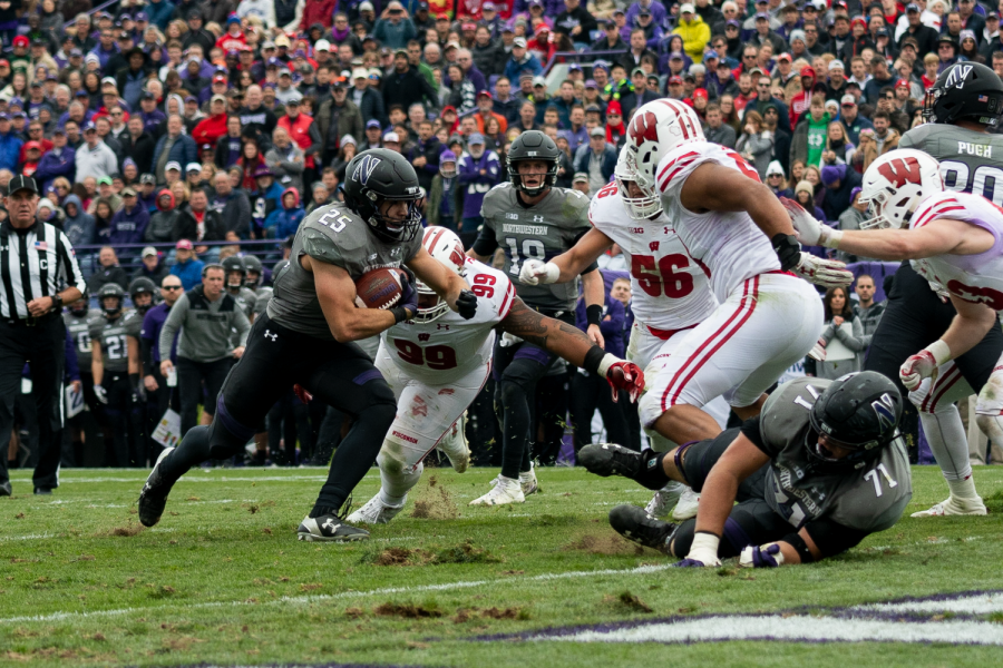 Isaiah Bowser rumbles toward the goal line during Northwesterns win over Wisconsin on Saturday. Bowser carried the ball 34 times and out-gained Wisconsin star Jonathan Taylor.