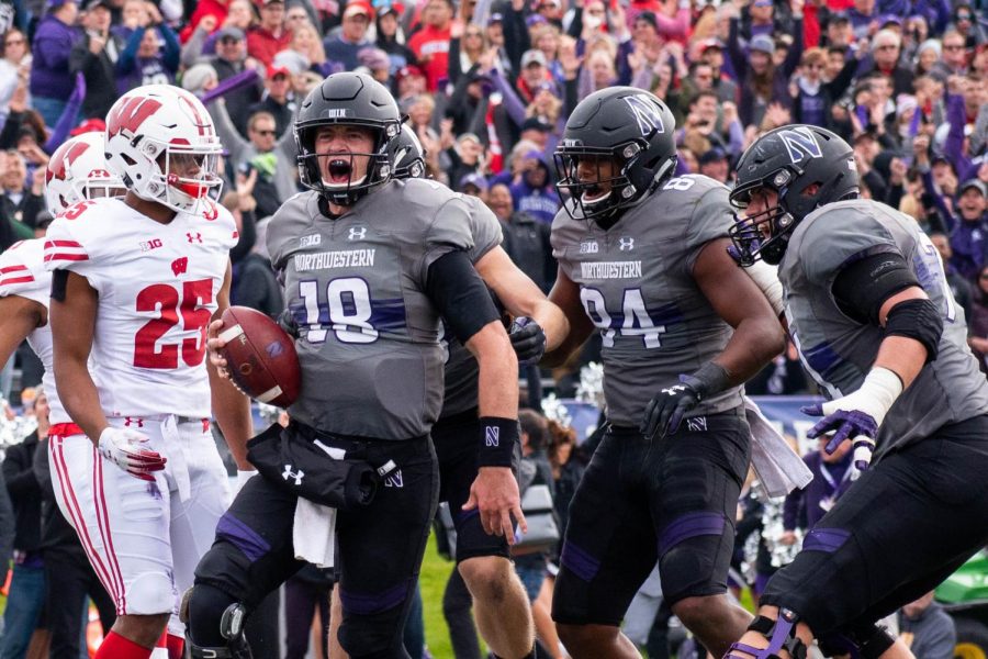 Clayton Thorson celebrates a touchdown. Thorson and the Wildcats secured a landmark win Saturday against Wisconsin.