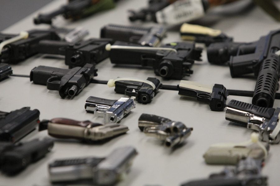 Confiscated guns on display at police headquarters in Chicago. Despite a 28 percent reduction in shootings since last year, Chicago is still one of America's deadliest cities.