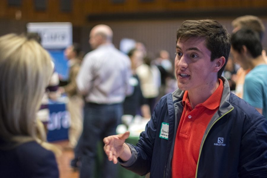 A recruiter talks at a 2014 career fair. Geni Harclerode, director of employer recruitment and engagement at NCA, said the career fair gives students the opportunity to meet with over 170 different employers over two days.