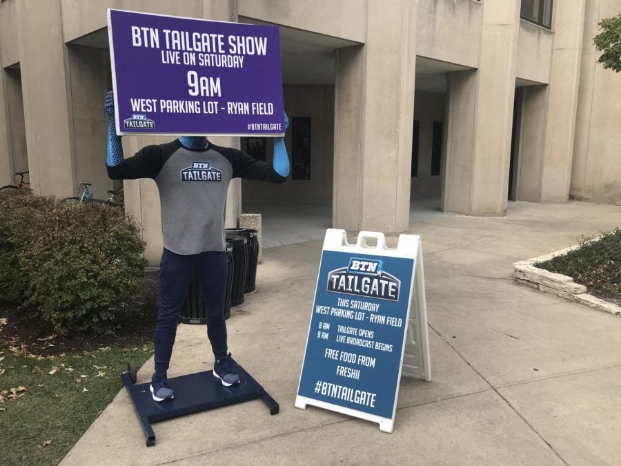 A mannequin holds up a sign for BTN Tailgate. The television program will be broadcasting from a parking lot next to Ryan Field on Saturday.