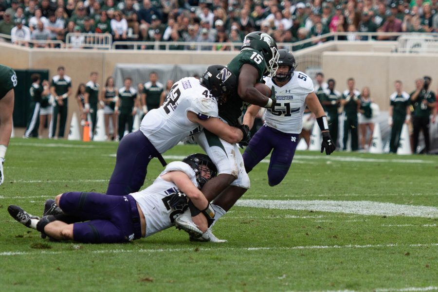 Sophomore linebackers Chris Bergin, a former walk-on, and Paddy Fisher tackle Michigan State running back La’Darius Jefferson earlier this month. Bergin is among several former walk-ons now contributing significantly for Northwestern.