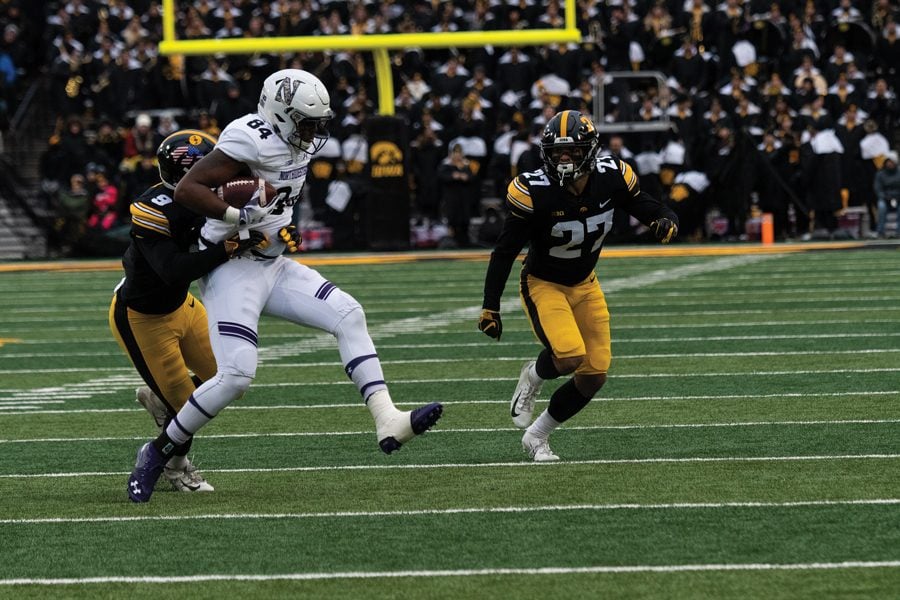 Cam Green fights through a Iowa tackle. The win gave Northwestern a place in Big Ten Championship game, ensuring that they will play 14 games this season. 