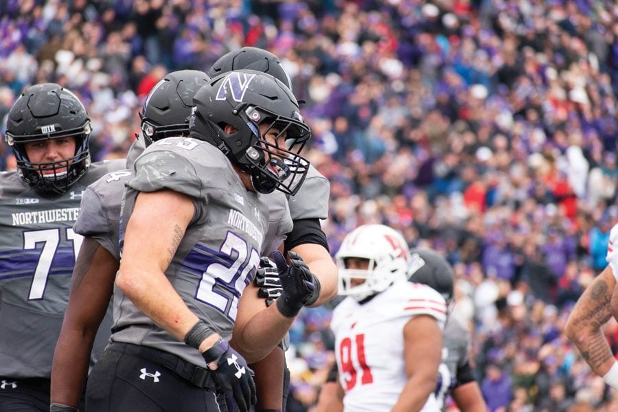  Isaiah Bowser celebrates a touchdown in Northwestern’s game against Wisconsin. Bowser has become a celebrity in his hometown of Sidney, Ohio. 