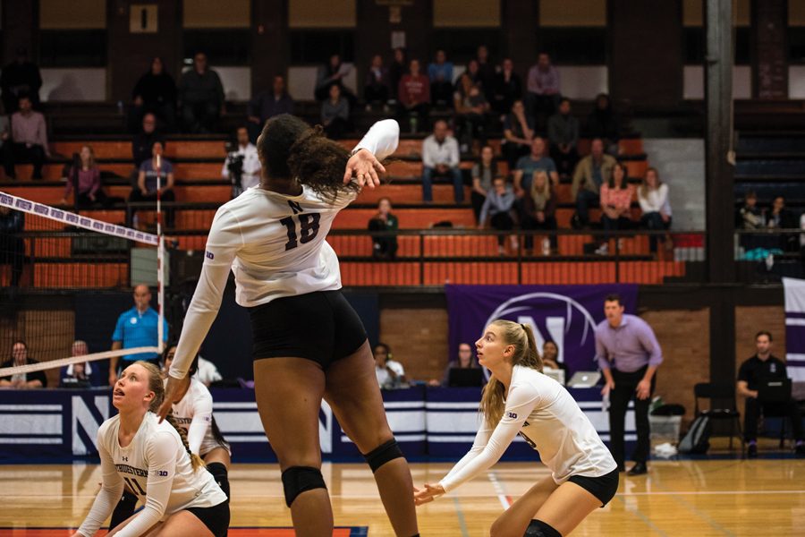 Nia Robinson jumps to hit the ball. The sophomore outside hitter and the Wildcats struggled throughout the 3-0 loss.
