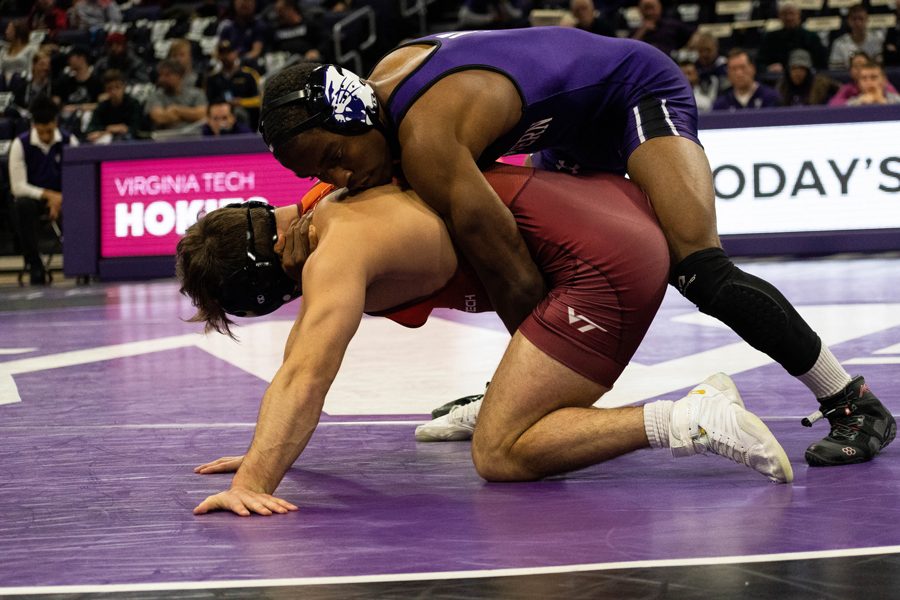 Yahya Thomas wrestles an opponent. The junior dominated against Purdues Trey Kruse in the Season Opener, winning a 13-3 major decision.