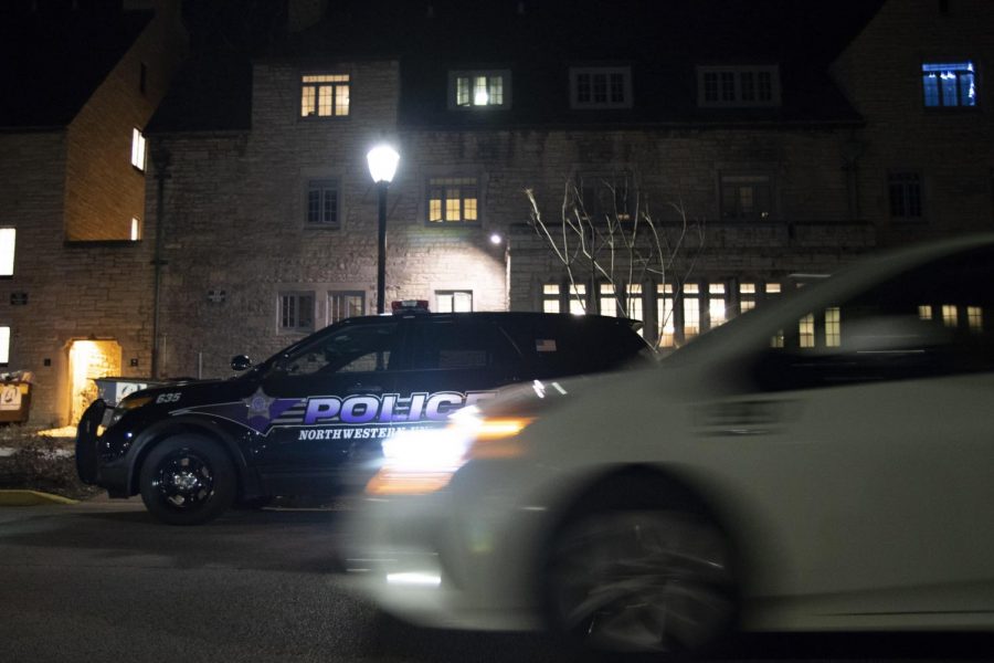 A Safe Ride drives past a University Police car near the Sorority Quad.