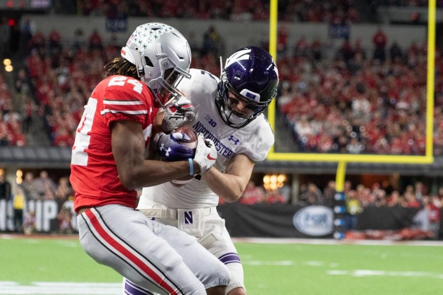 Ohio State cornerback Shawn Wade grabs the ball from Flynn Nagel. NU committed three costly turnovers in Saturdays loss.