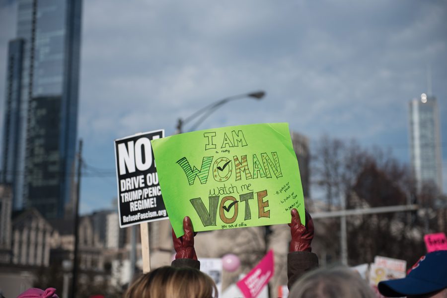 A sign at the Chicago Women’s March 2018 reads “I am woman, watch me vote.” Chicago organizers cancelled the event for 2019, citing logistics.