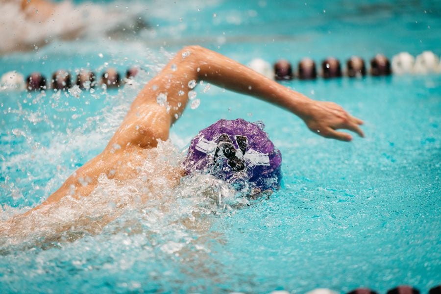 A Northwestern swimmer swims the freestyle. The Wildcats split two weekend meets this week