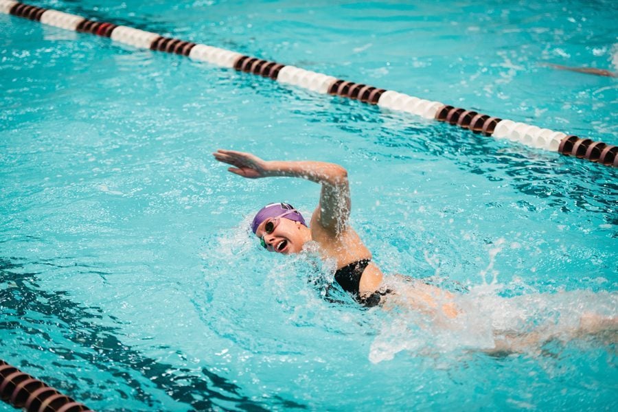 A Northwestern swimmer swims freestyle. The women’s team split its matches this weekend in Iowa