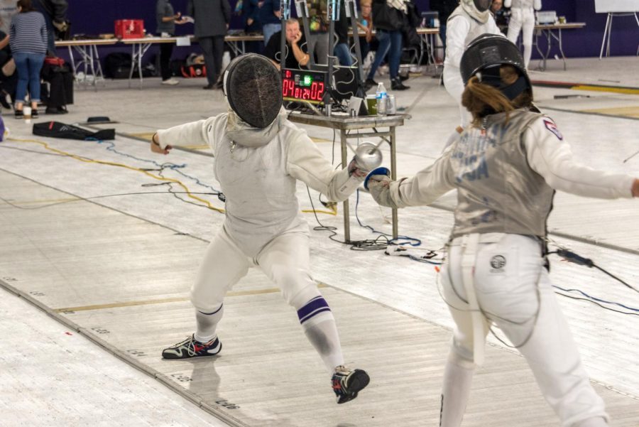 A Northwestern fencer clashes swords with an opponent. The Wildcats are headed to Philadelphia this weekend.