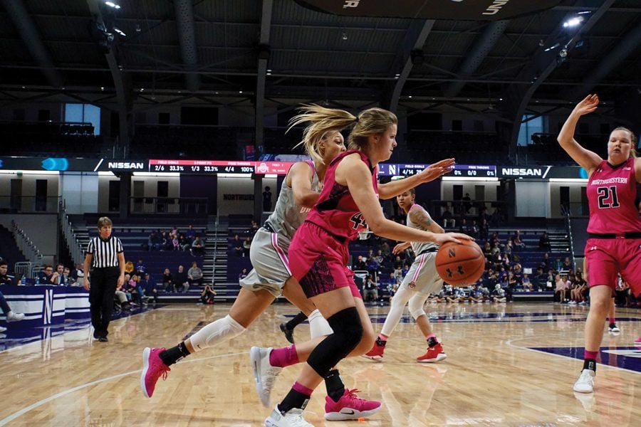 Abi Scheid drives to the basket. The junior forward contributed 18 points in NU’s overtime loss.