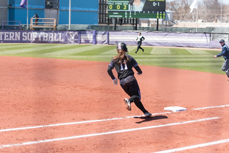 Rachel Lewis rounds first base. She hit a home run in her first at-bat of the season Friday.