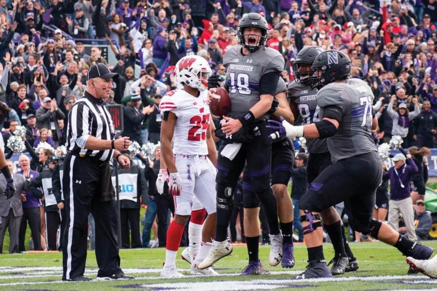 Clayton Thorson celebrates with his teammates after a score in a 2018 game. The quarterback was selected by the Philadelphia Eagles in this weekend’s NFL Draft.