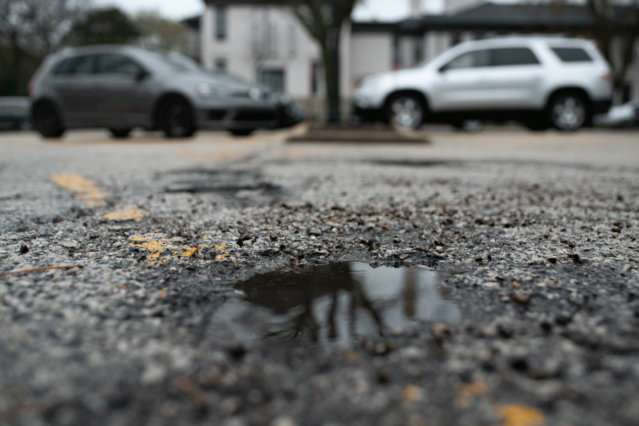 Water fills a pothole at the lot near Tallmadge Park. Construction is scheduled to begin as early as next week.
