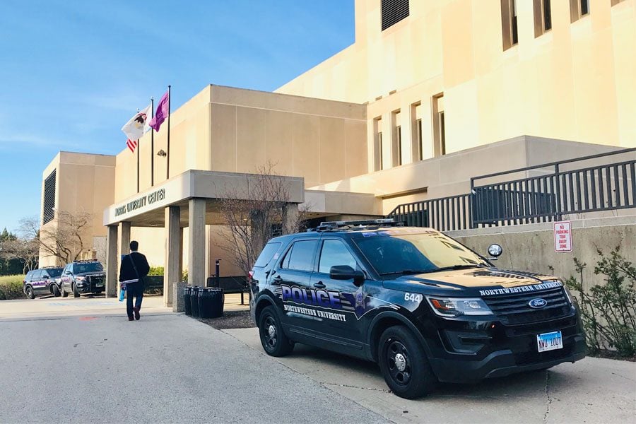 Police cars outside of Norris University Center on Tuesday. A third “It’s okay to be white” message was found in a women’s bathroom inside the building.