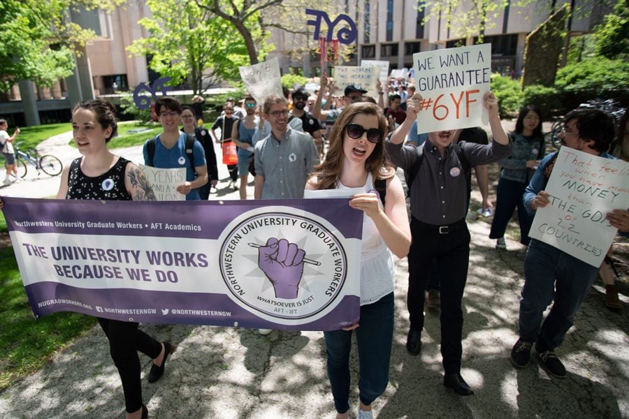 Graduate students march from Main Library to Rebecca Crown Center. Students, led by Northwestern Graduate Workers, rallied in support of guaranteed sixth-year funding on Thursday afternoon.