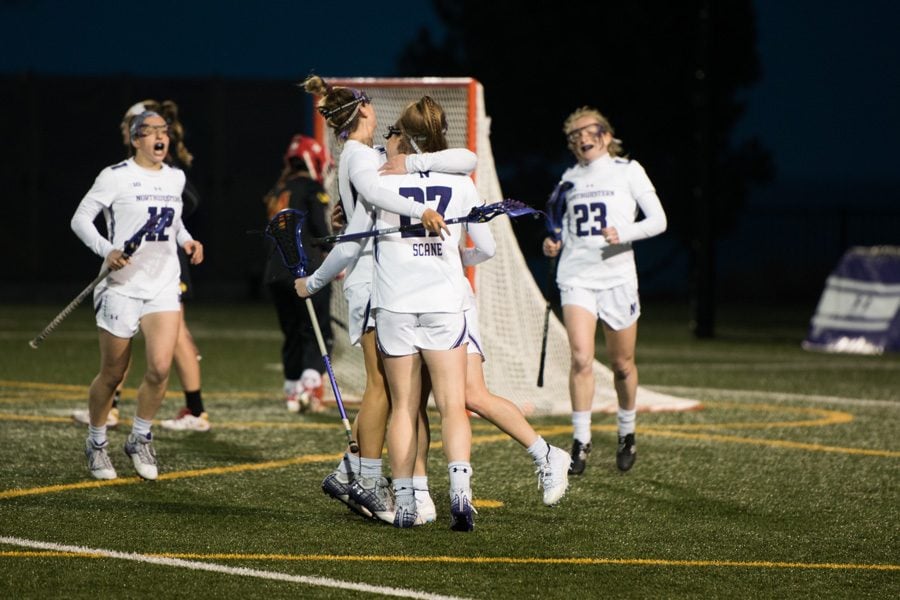Izzy Scane celebrates a goal with her teammates. The freshman is second on the team in both goals and points this season.