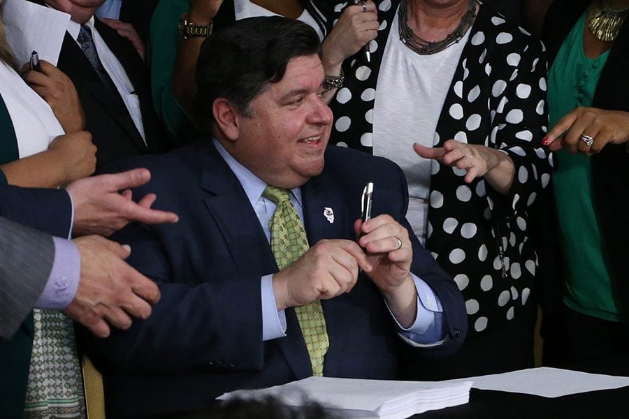 Gov.+J.B.+Pritzker+signs+a+bill+legalizing+the+use+and+sale+of+recreational+marijuana+in+Illinois+on+Tuesday.+The+state+is+now+the+11th+to+have+such+legislation.