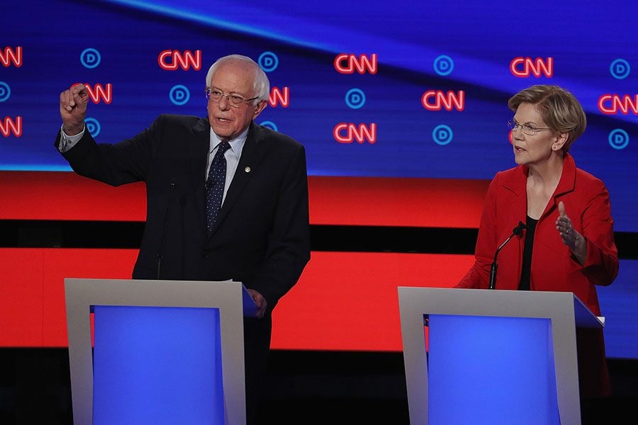 Democratic presidential candidate Sen. Bernie Sanders (I-Vt.), left, and Sen. Elizabeth Warren (D-Mass.) speak during the Democratic Presidential Debate at the Fox Theatre on Tuesday, July 30, 2019, in Detroit. 