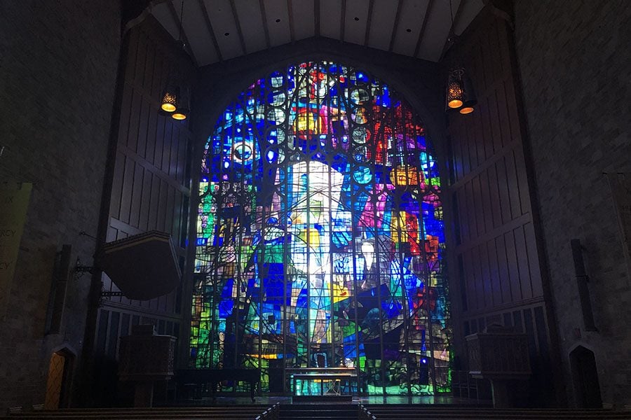 The chancel window behind the altar of the Alice Millar Chapel, designed by Benoit Gilsoul. The window represents creation, redemption and triumph.