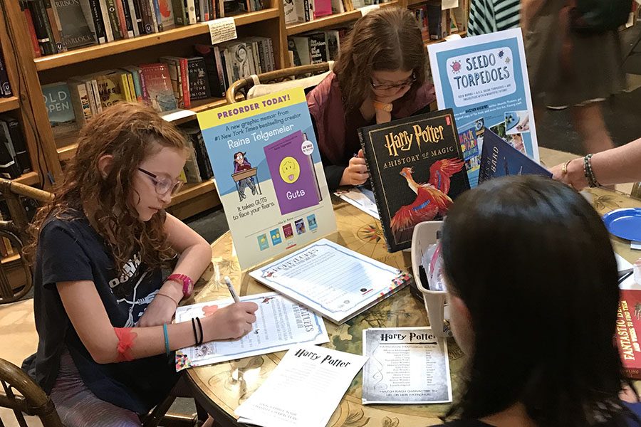 Kids fill out Harry Potter-themed word puzzles at a special event hosted by Bookends & Beginnings on Wednesday evening.