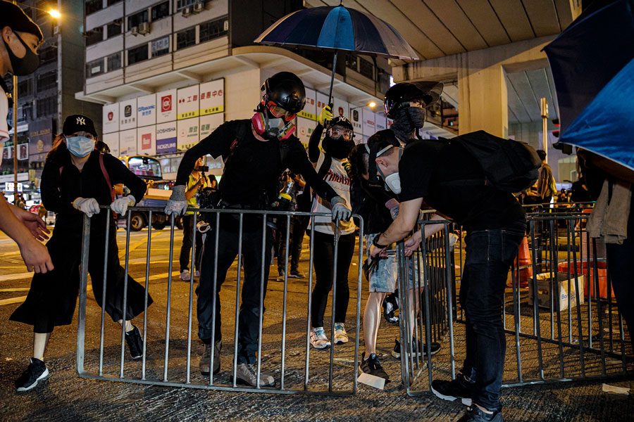 rotesters set up road blocks on Nathan Road, a busy main street, outside the Mong Kok police station in Hong Kong, on September 8, 2019.