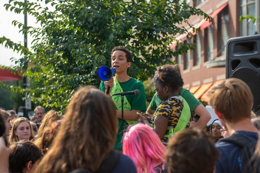Aldric+Martinez-Olson%2C+ETHS+senior+and+student+organizer%2C+speaks+to+the+crowd+of+400+community+members+gathered+for+the+climate+strike.+Students+demanded+climate+justice+in+addition+to+climate+action.