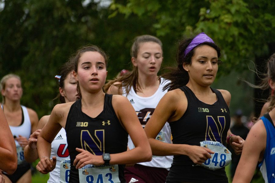 Kayla Byrne (left) runs in the Loyola Lakefront Invite. The freshman finished the 5K with a time of 19:14.03.