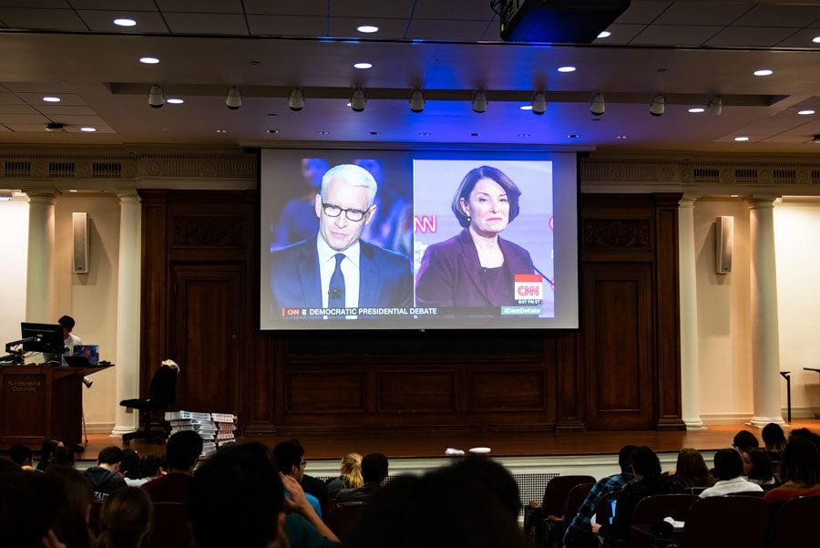 Students watch the Democratic Presidential Debate at Harris Hall. The presidential hopefuls debated topics such as the impeachment, the Middle East, health care, and gun control.